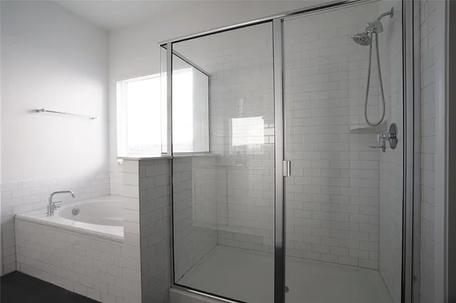 an empty room with wooden floor and ceiling fan