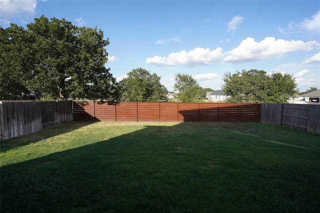 an empty room with wooden floor and closet