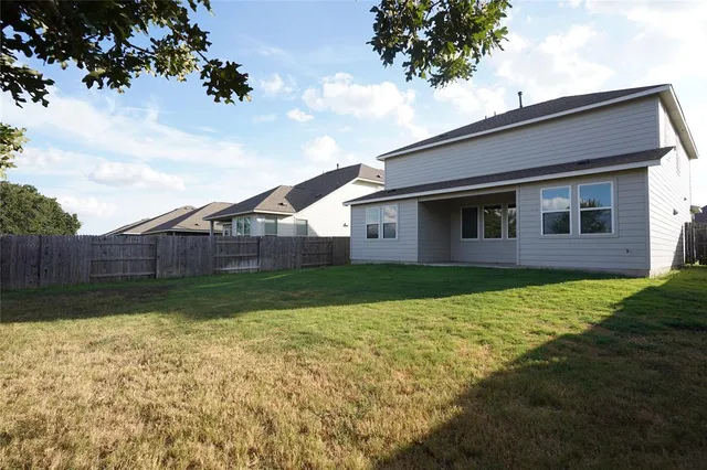 an empty room with wooden floor and window