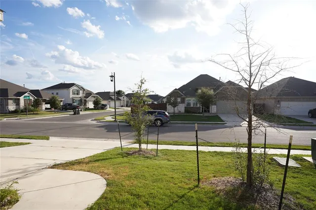 a view of yard with swimming pool and wooden fence