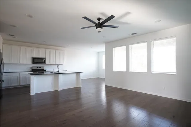 a view of a yard in front of a house with large trees