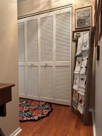 a bedroom with a bed and a lamp on dresser