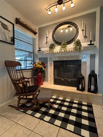 a living room with furniture a flat screen tv and a large window
