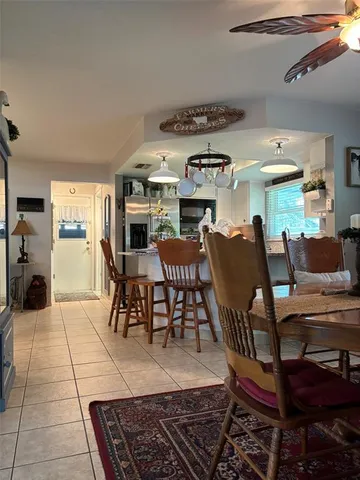 a view of a chair and table in the back yard of the house