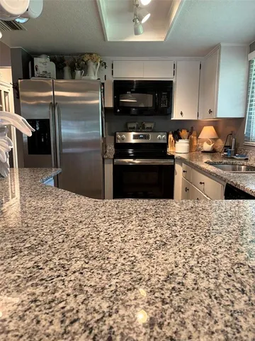 a terrace with outdoor seating and trees