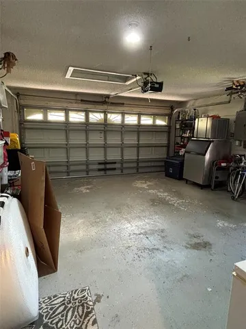 an aerial view of residential house with outdoor space and trees all around