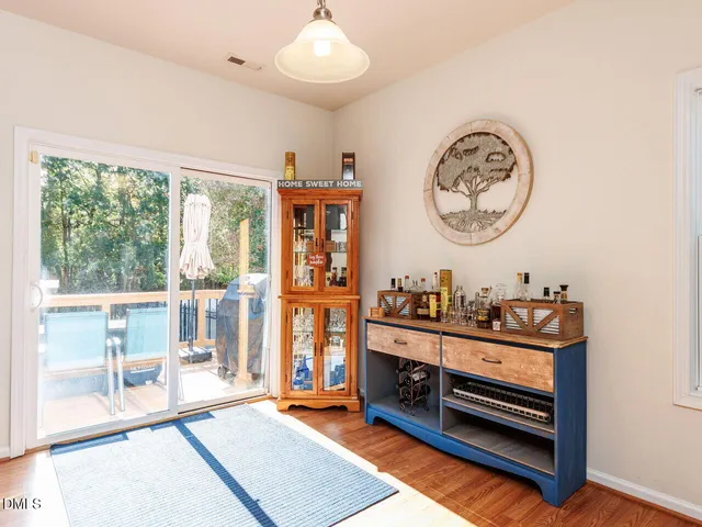 a view of a dining room with furniture and wooden floor