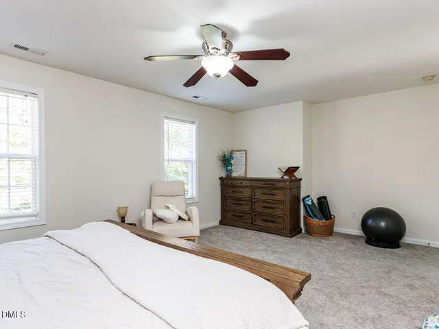 a living room with furniture a large window and a clock on the wall