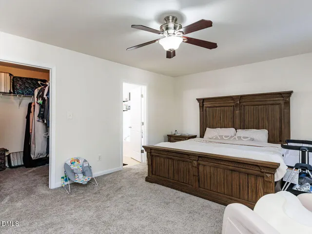 a dining room with furniture and a large window