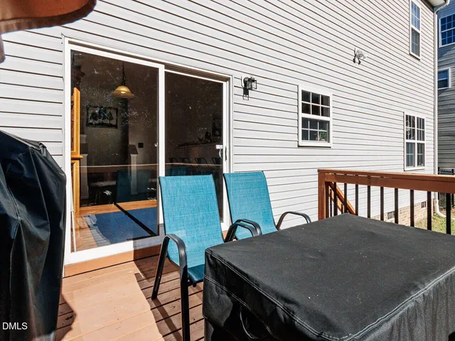 a living room with furniture and a baby crib