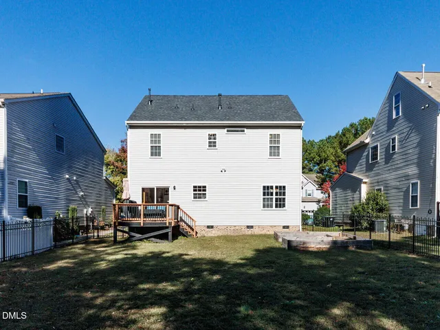 a view of a patio with table and chairs and floor to ceiling window