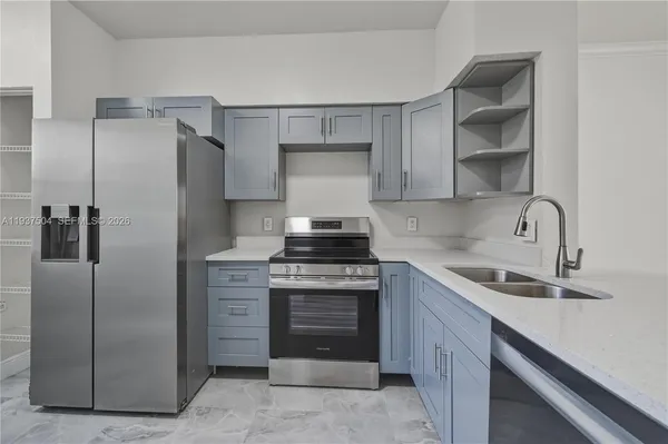 a kitchen with a stove and a sink