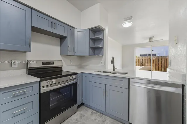 a kitchen with cabinets and stainless steel appliances