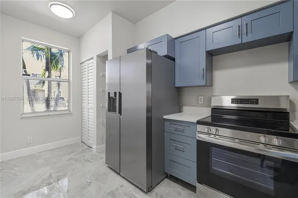 a view of staircase with lots of frames on wall and a window