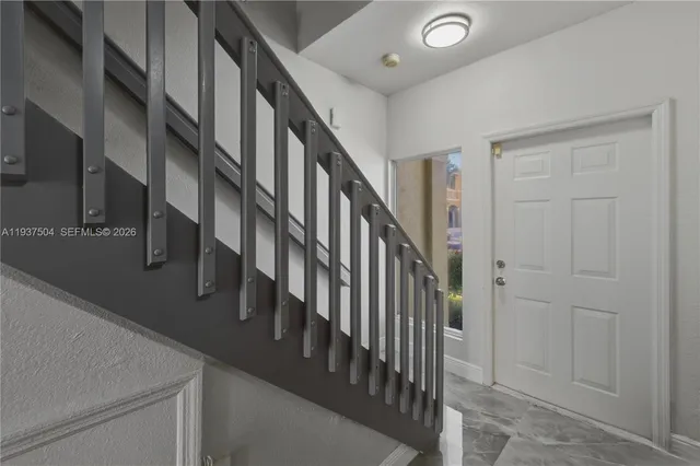 a view of entryway and hall with wooden floor