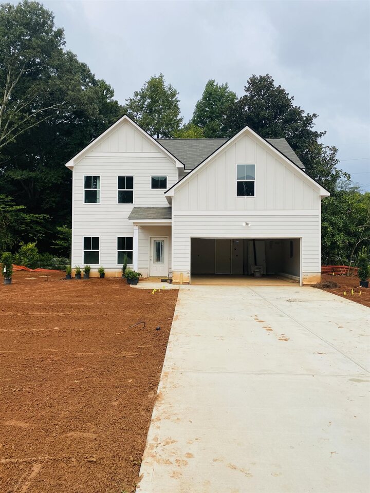 2053 Easterwood Court, Unit 1 Decatur, GA 30032 - Photo 1 of 1 a view of a white house with a yard
