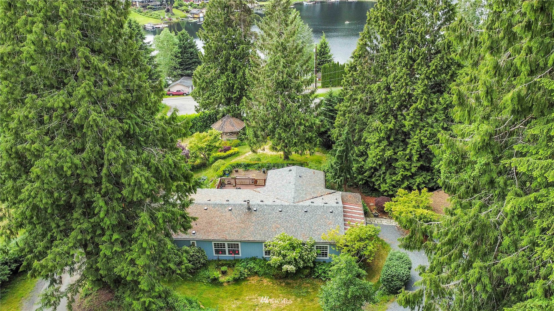 2721 South Lake Roesiger Road Snohomish, WA 98290 - Photo 1 of 26 an aerial view of a house with a yard and large trees