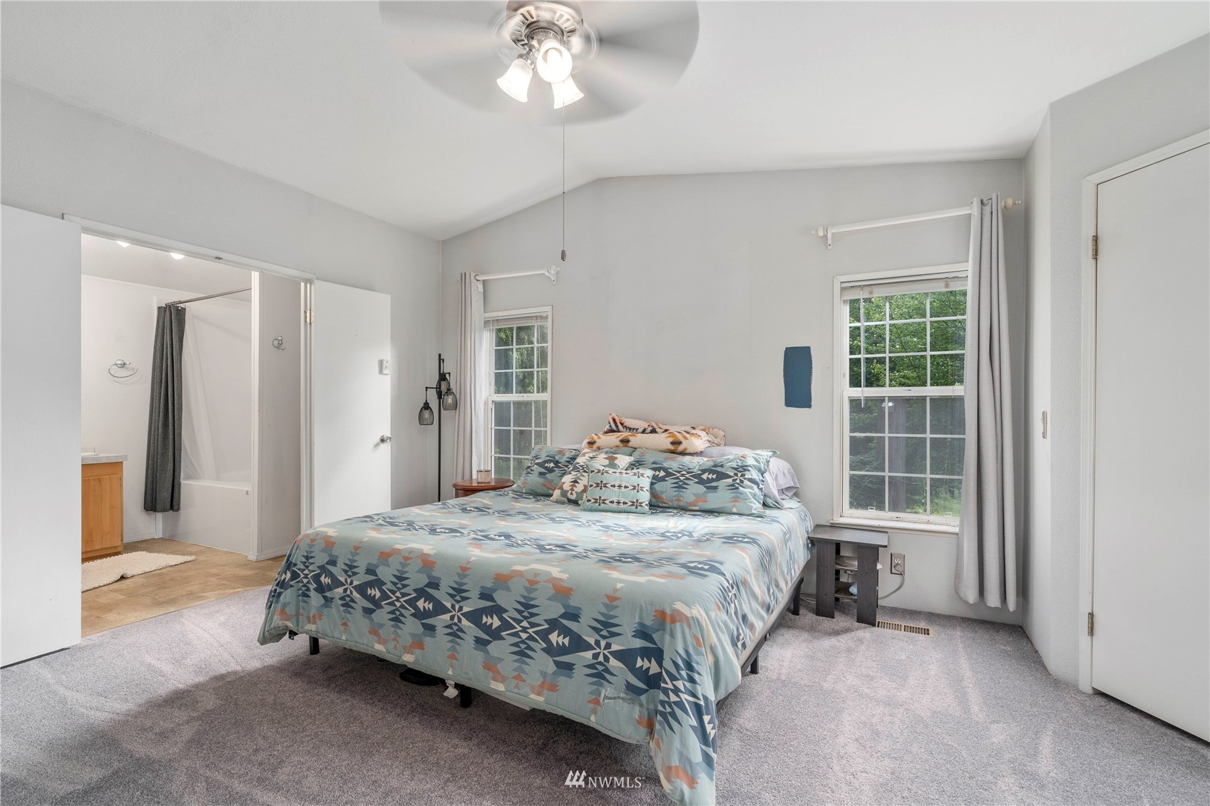 2721 South Lake Roesiger Road Snohomish, WA 98290 - Photo 15 of 26 a bedroom with a bed and a chandelier