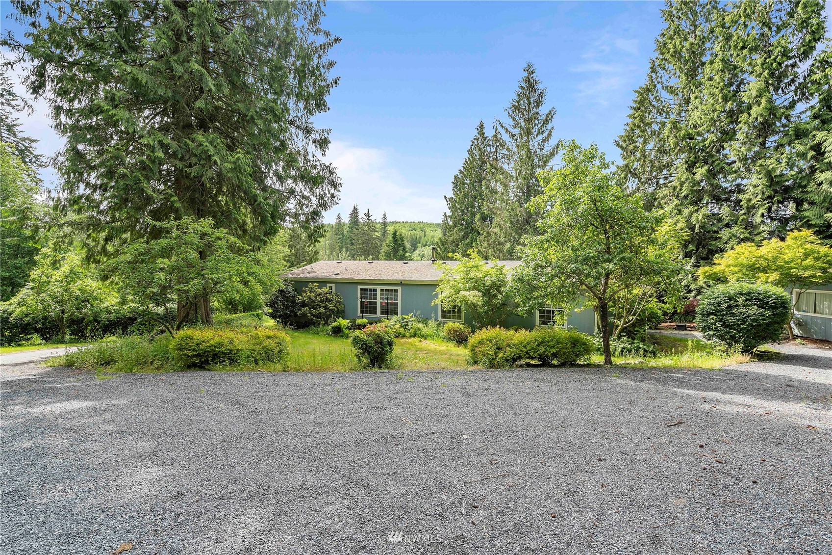 2721 South Lake Roesiger Road Snohomish, WA 98290 - Photo 3 of 26 a view of a house with a yard and large trees