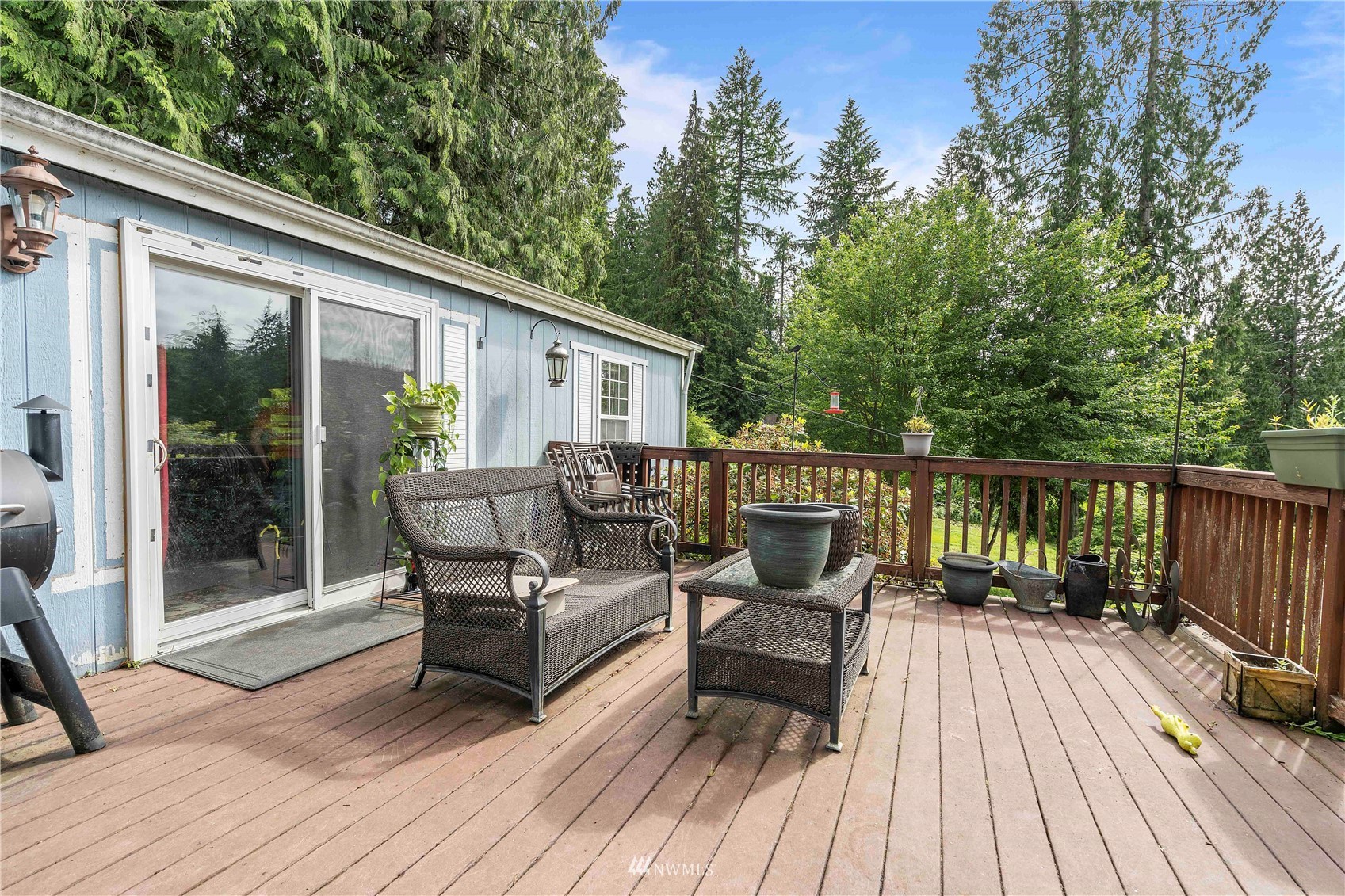 2721 South Lake Roesiger Road Snohomish, WA 98290 - Photo 8 of 26 a view of house with deck outdoor seating and trees in the background