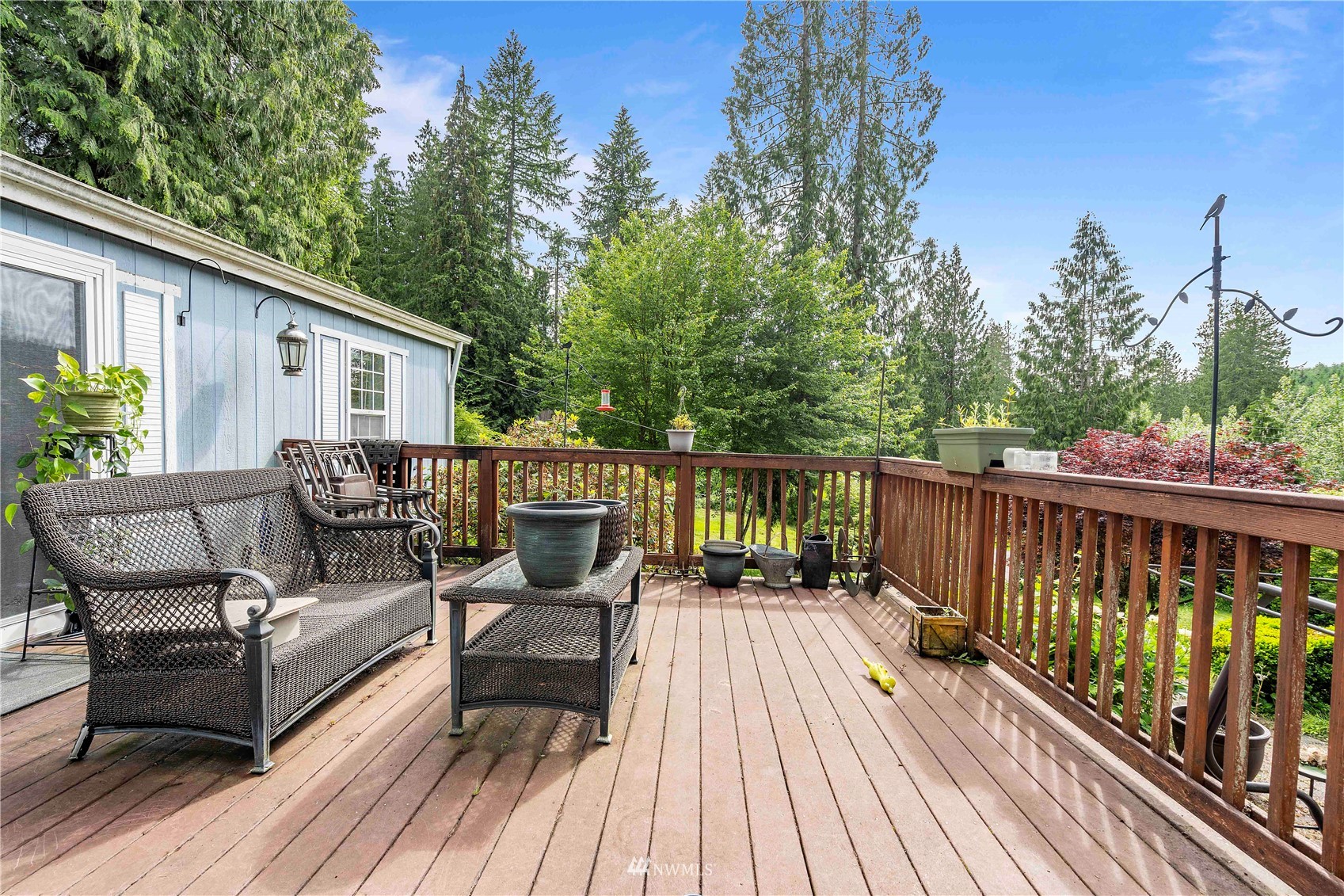 2721 South Lake Roesiger Road Snohomish, WA 98290 - Photo 9 of 26 a view of a balcony with two chairs and wooden floor