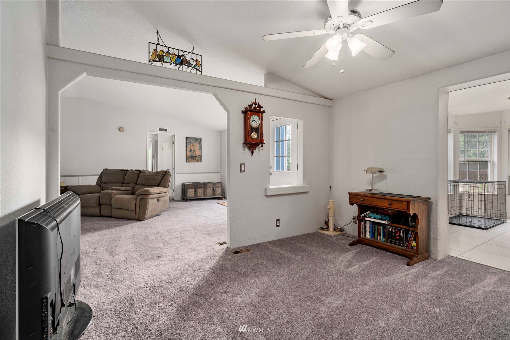 2721 South Lake Roesiger Road Snohomish, WA 98290 - Photo 10 of 26 a living room with furniture and a chandelier
