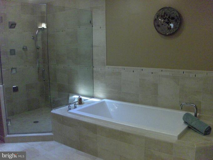 10704 Hunters Valley Road Vienna, VA 22181 - Photo 11 of 26 Large soaking tub and glass shower
