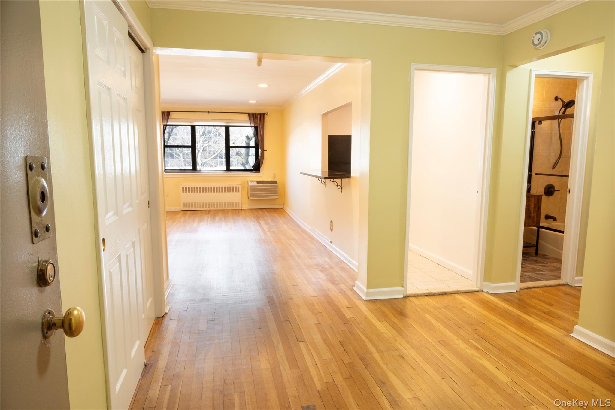 a view of a hallway with wooden floor and windows