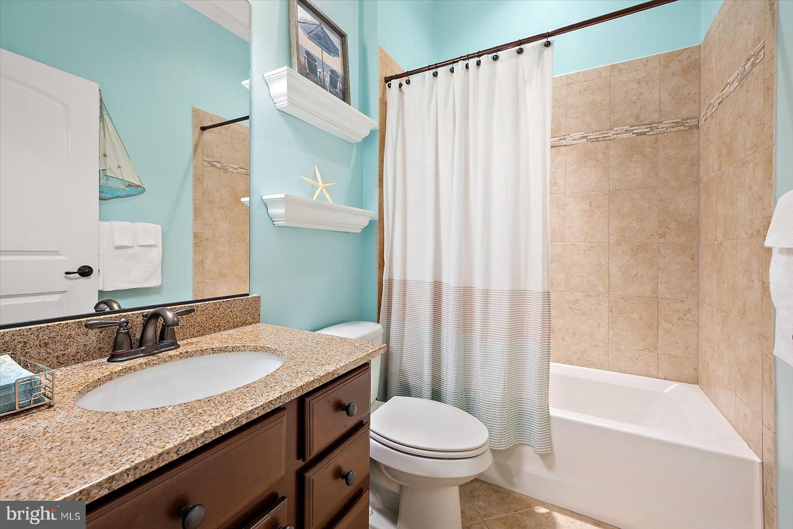 38896 Blue Indigo Road Selbyville, DE 19975 - Photo 46 of 86 a bathroom with a granite countertop sink toilet and shower