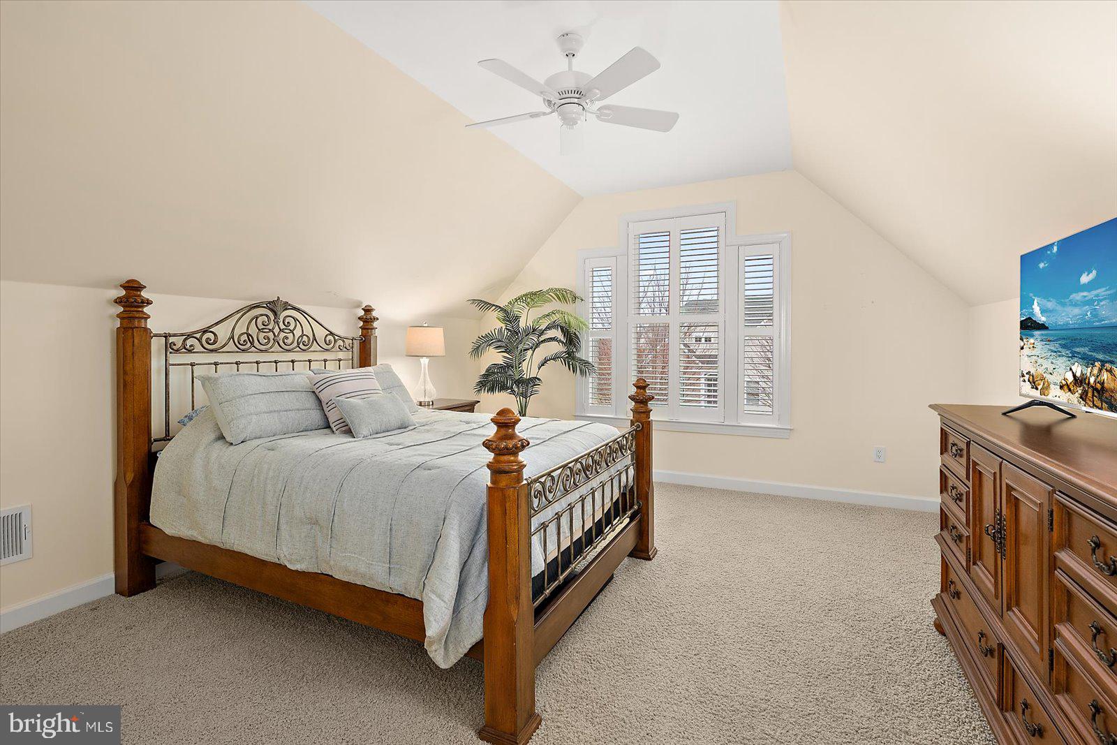 38896 Blue Indigo Road Selbyville, DE 19975 - Photo 49 of 86 a spacious bedroom with a bed and a chandelier