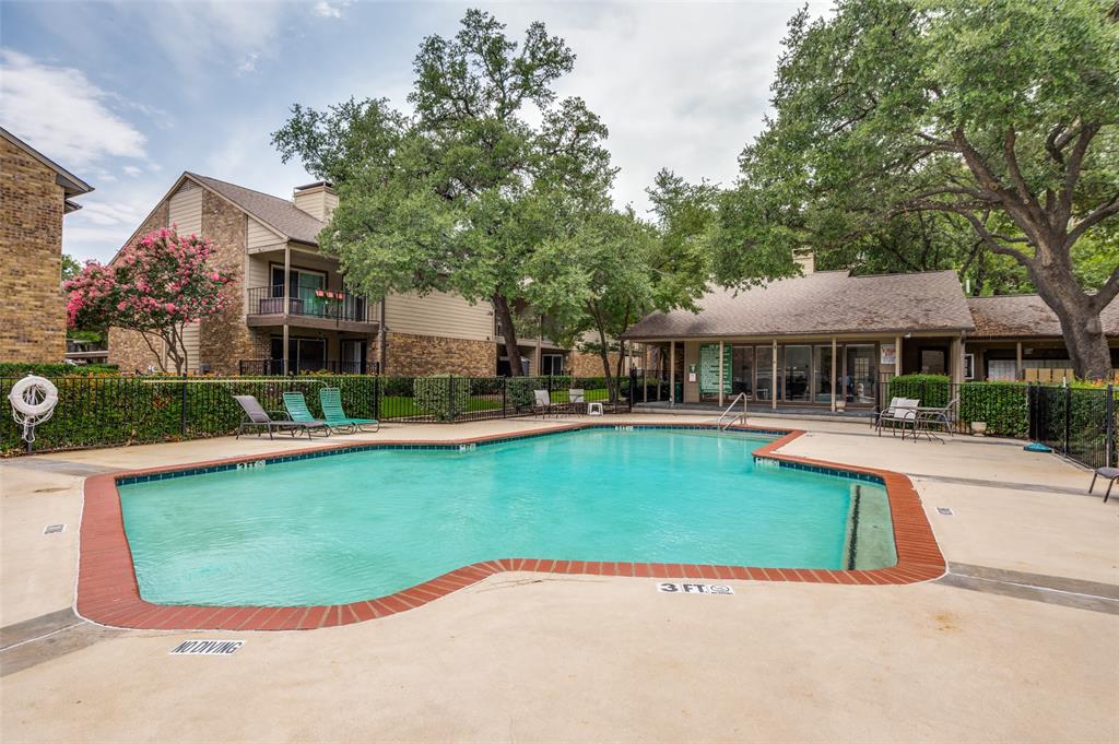 5300 Keller Springs Road, Unit 2042 Dallas, TX 75248 - Photo 26 of 28 Resort-style pool with red brick coping, surrounded by a concrete deck