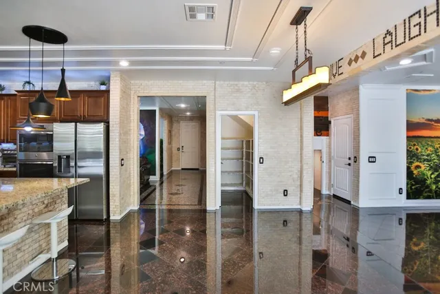 a kitchen with stainless steel appliances granite countertop a sink and a refrigerator
