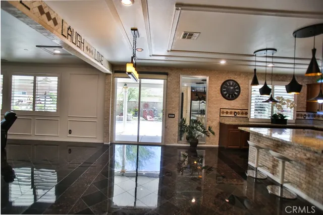 a living room with furniture and a floor to ceiling window