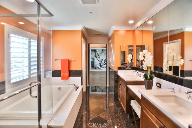 a large kitchen with a counter space a sink and stainless steel appliances
