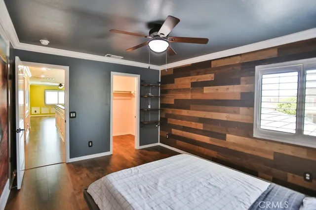 a view of a living room with a table and a ceiling fan