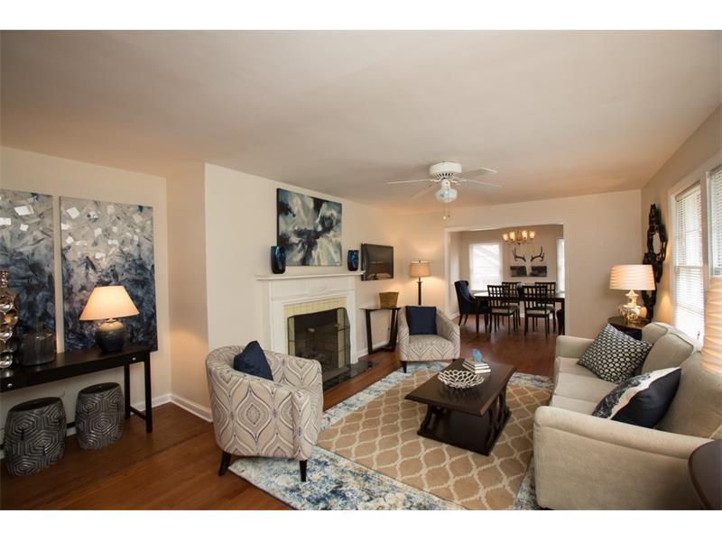 This charming living room opens directly on to dining room. Wonderful sunlight creates bright living space