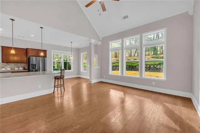 a large kitchen with kitchen island a large counter top stainless steel appliances and a center island