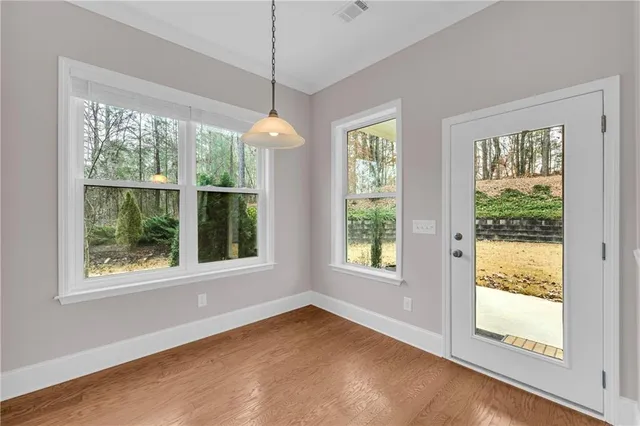 a view of room with window ceiling fan and hardwood floor