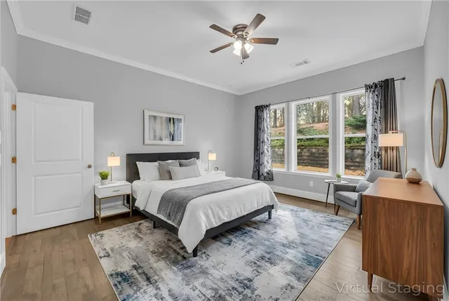 a view of an empty room with window and a ceiling fan