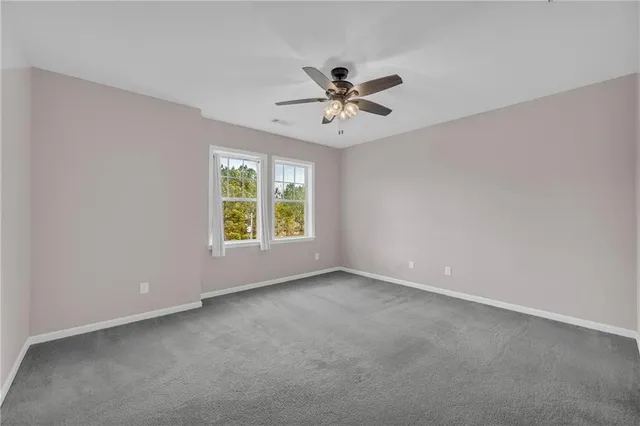 a view of a livingroom with a ceiling fan and window
