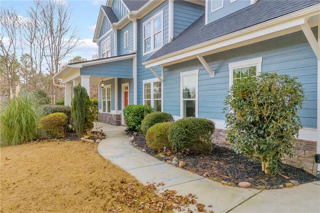 a view of a hallway with wooden floor and closet