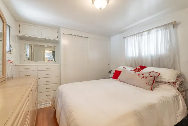 a bedroom with a bed and a dresser