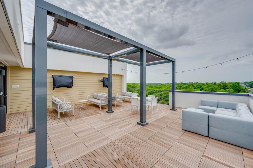 4801 Springdale Road, Unit 1307 Austin, TX 78723 - Photo 19 of 30 a roof deck with table and chairs