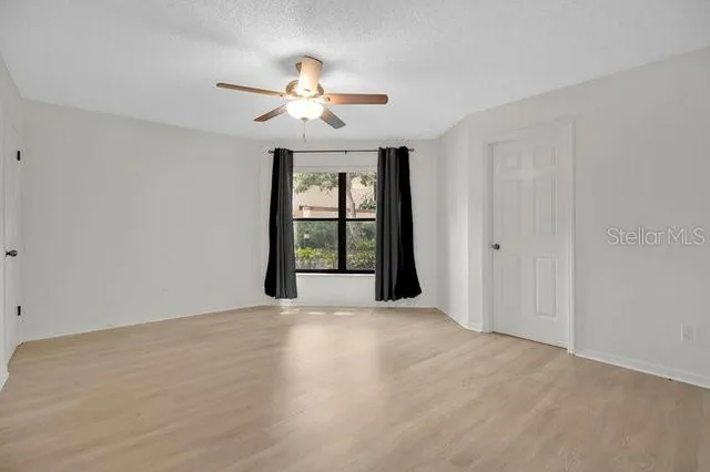 a bathroom with a tub a sink and a window