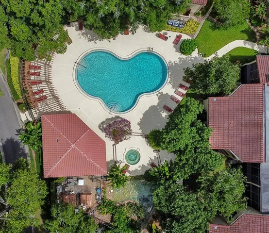 an aerial view of a house with yard swimming pool and outdoor seating