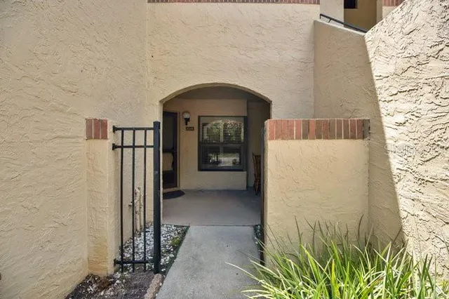 a view of a room with window ceiling fan and hardwood floor