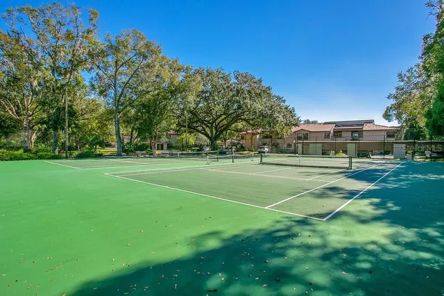 a car parked in front of a house with a yard