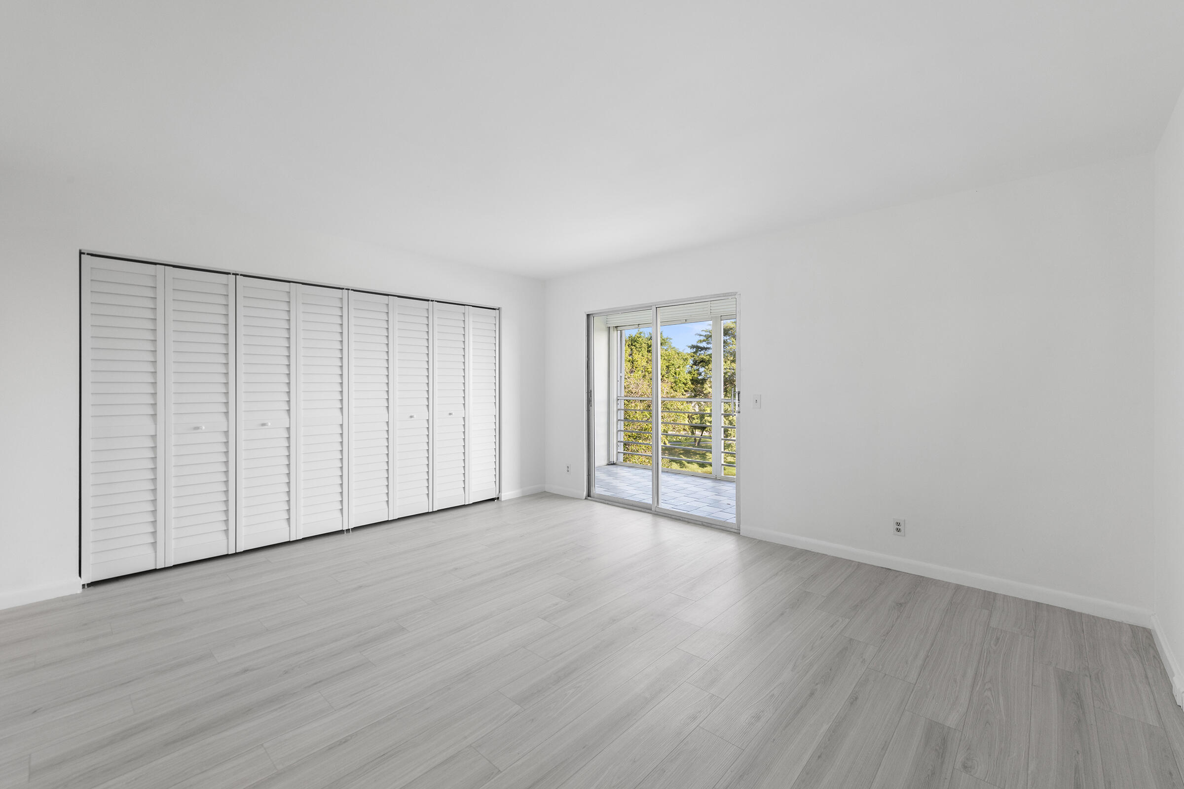 4043 Rexford Drive, Unit 4043 Boca Raton, FL 33434 - Photo 11 of 27 a view of an empty room with wooden floor and a window