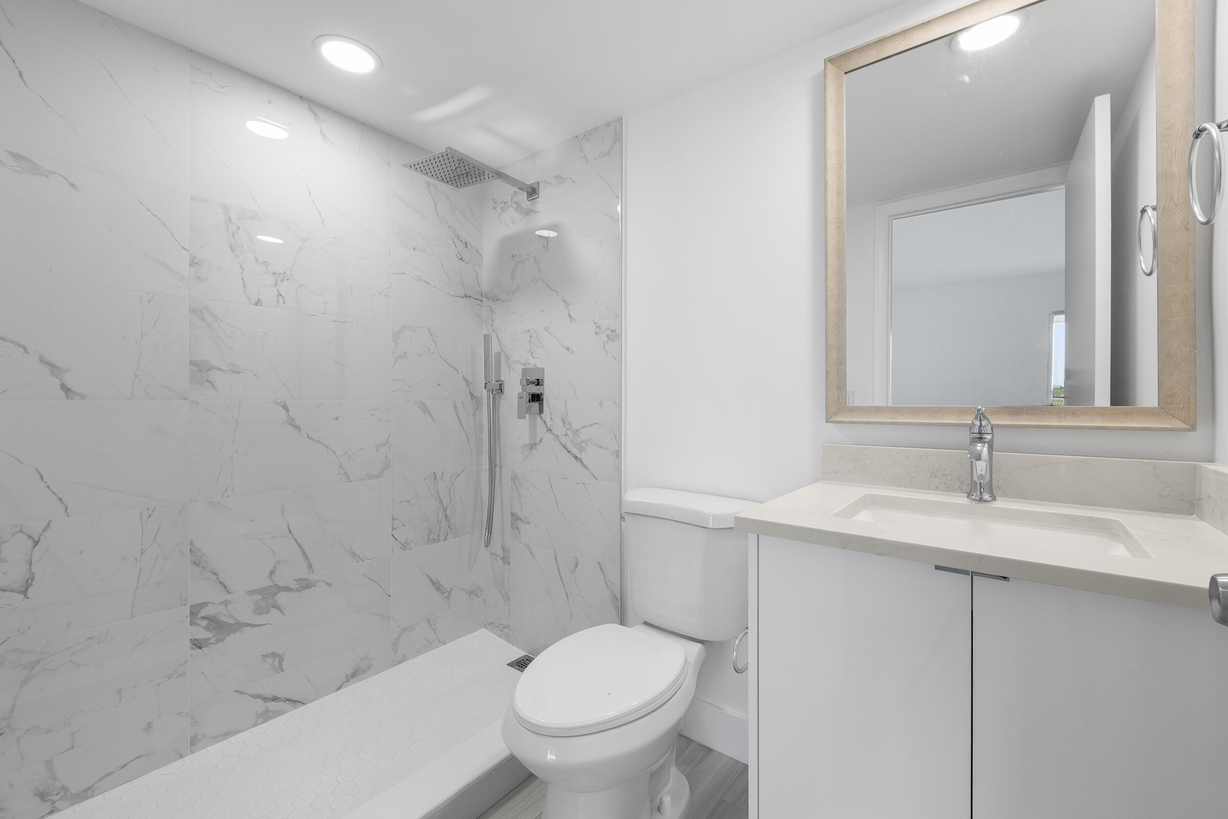 4043 Rexford Drive, Unit 4043 Boca Raton, FL 33434 - Photo 17 of 27 a bathroom with a granite countertop sink toilet and shower