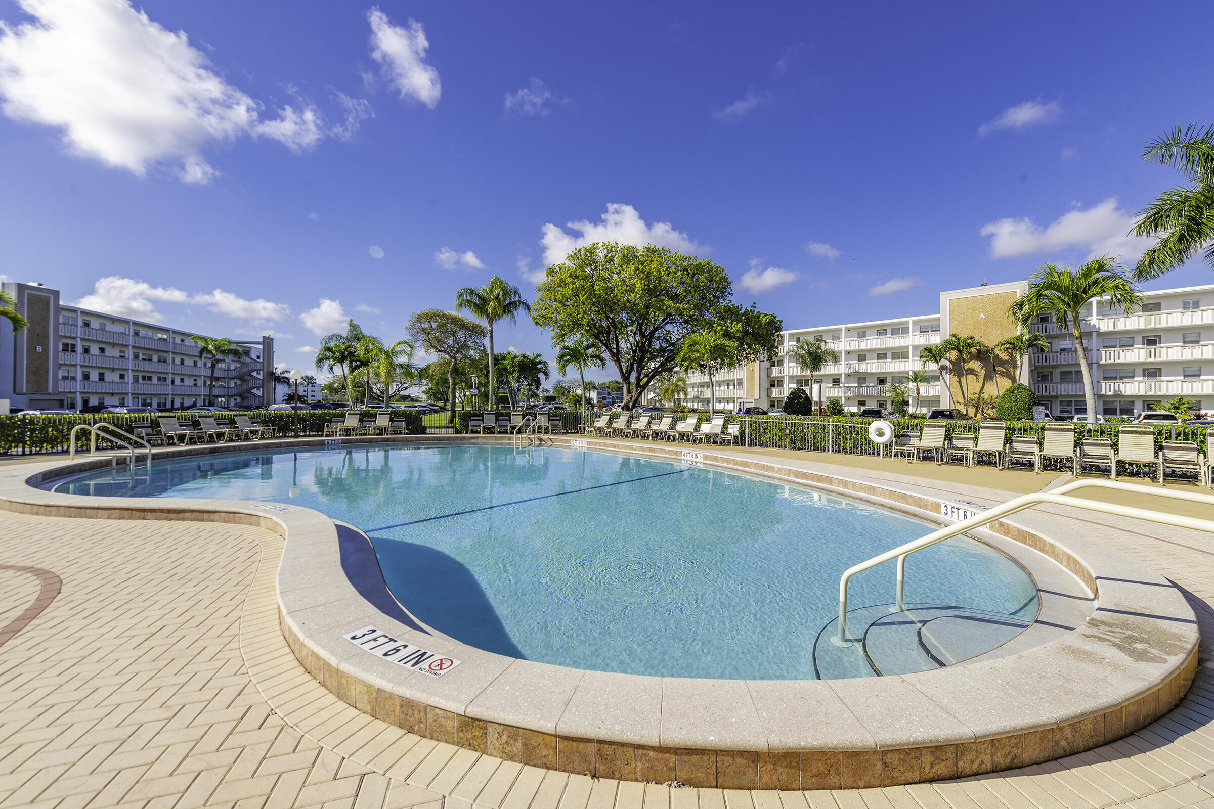 4043 Rexford Drive, Unit 4043 Boca Raton, FL 33434 - Photo 21 of 27 a view of a swimming pool in front of the house